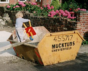 Melissa filling a skip.